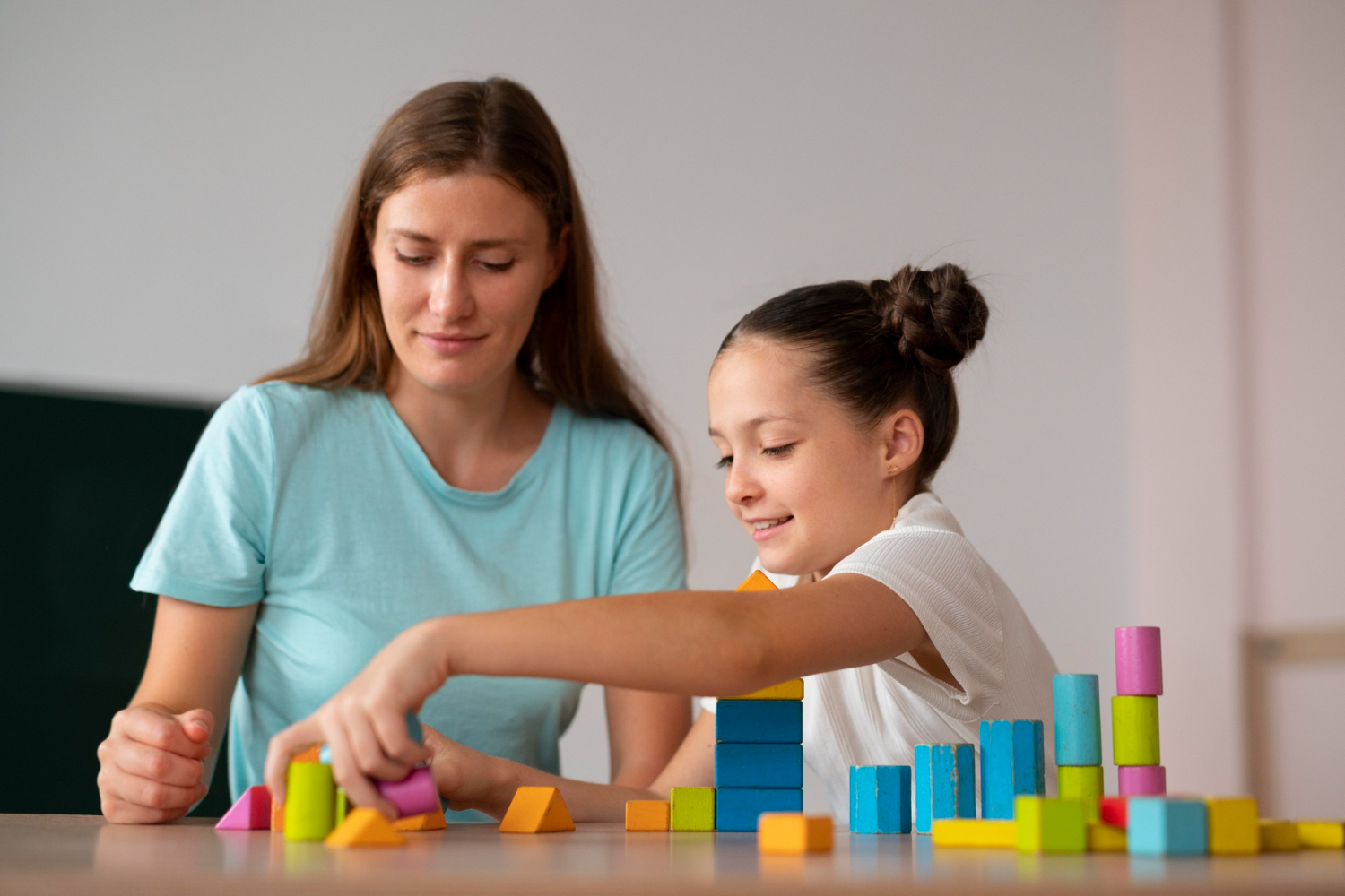 Occupational therapist guiding a child during play-based therapy