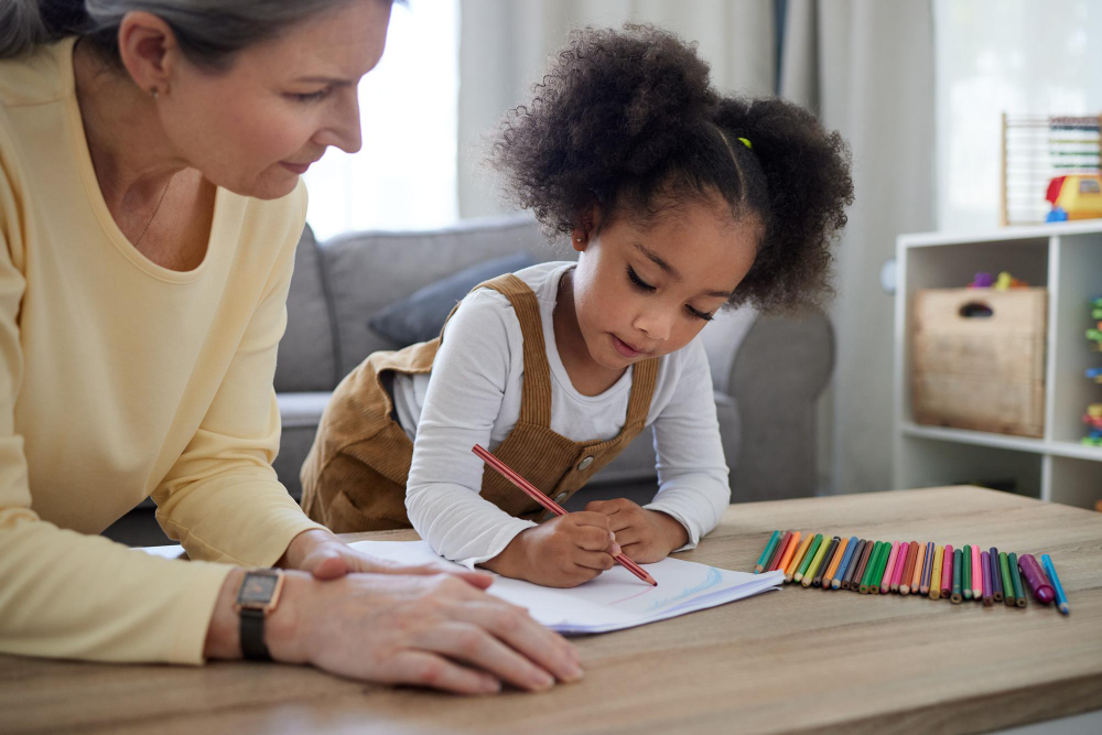 Teacher supporting a child during a focused learning activity